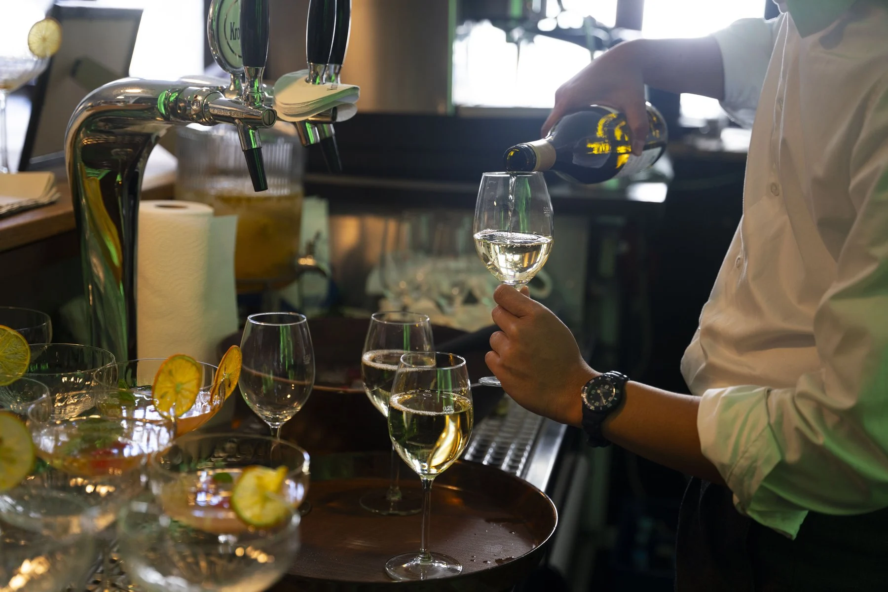 Wine being poured at the bar during a private gathering at La Maison Q.J.Bünzel, Neuss