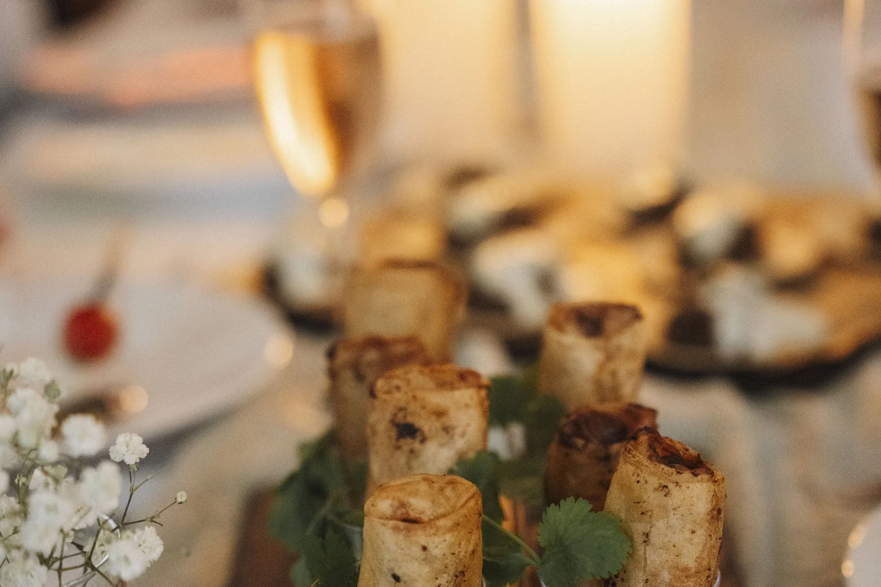 Spring rolls served in glasses by candlelight at a gathering at Haus Jordans, Neuss