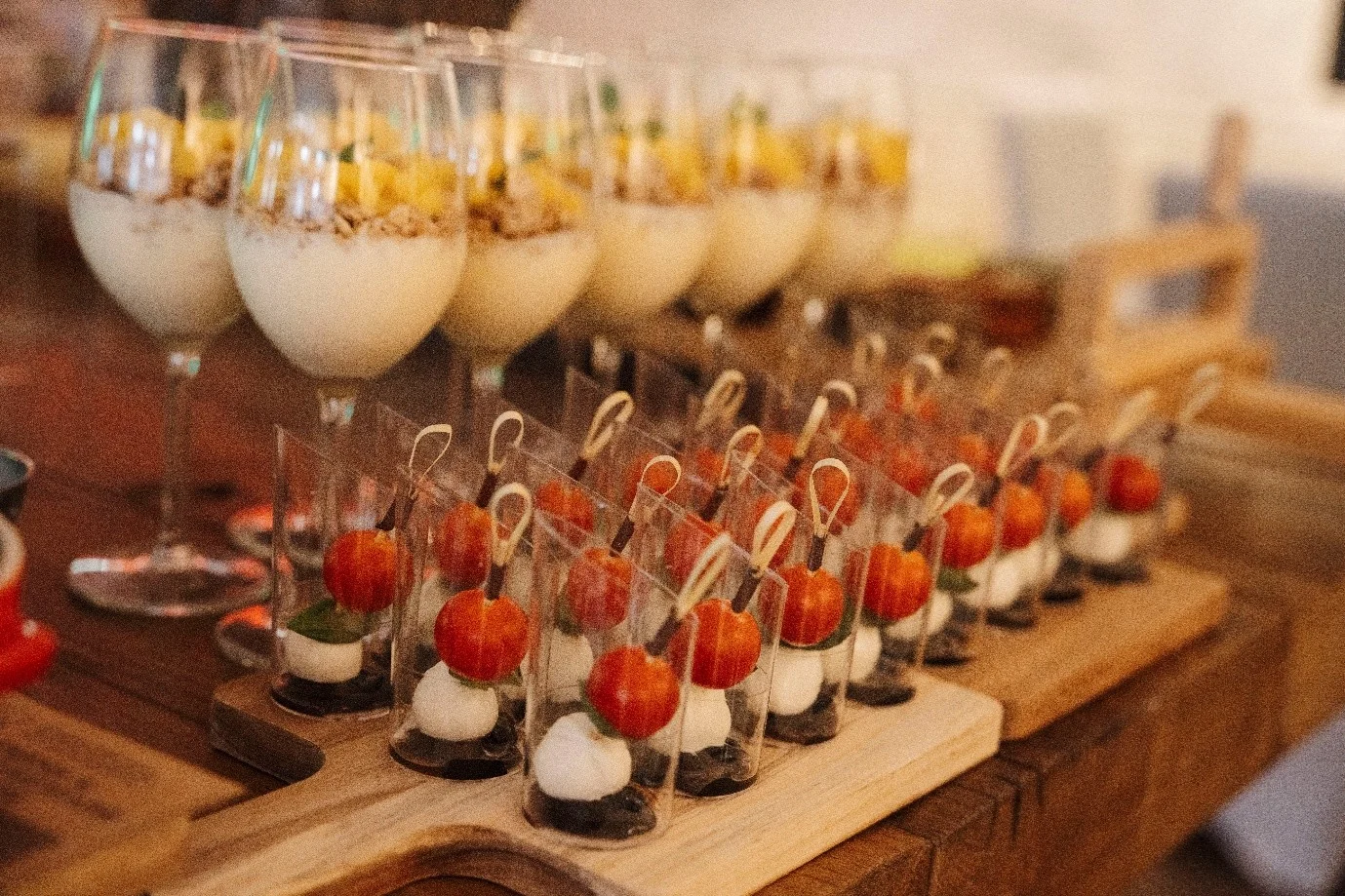 Tomato and mozzarella bites and dessert glasses on wooden boards at a buffet at Haus Jordans, Neuss