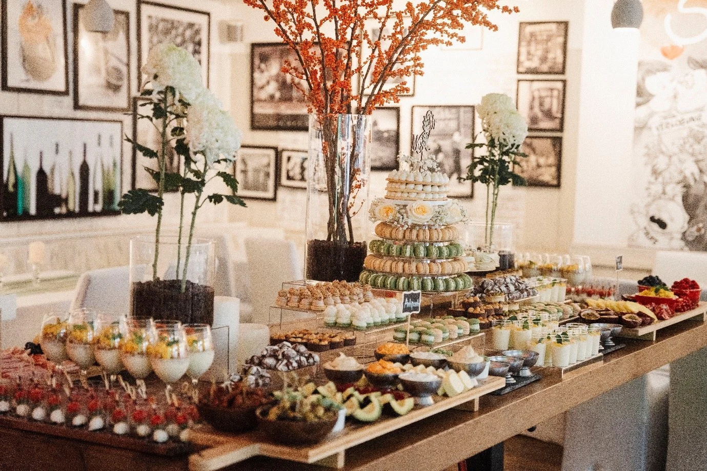 Buffet table with desserts, finger food and orange berry branches at a private event at Haus Jordans, Neuss